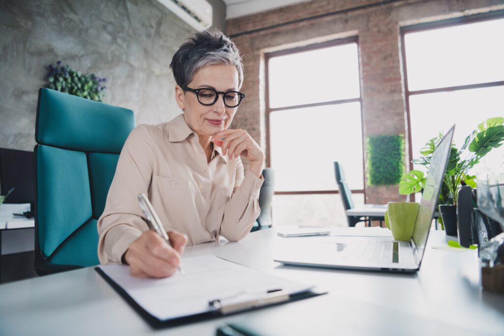 woman getting ready for retirement with a pen and paper