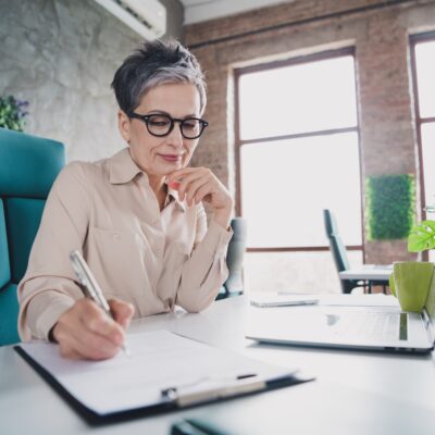 woman getting ready for retirement with a pen and paper