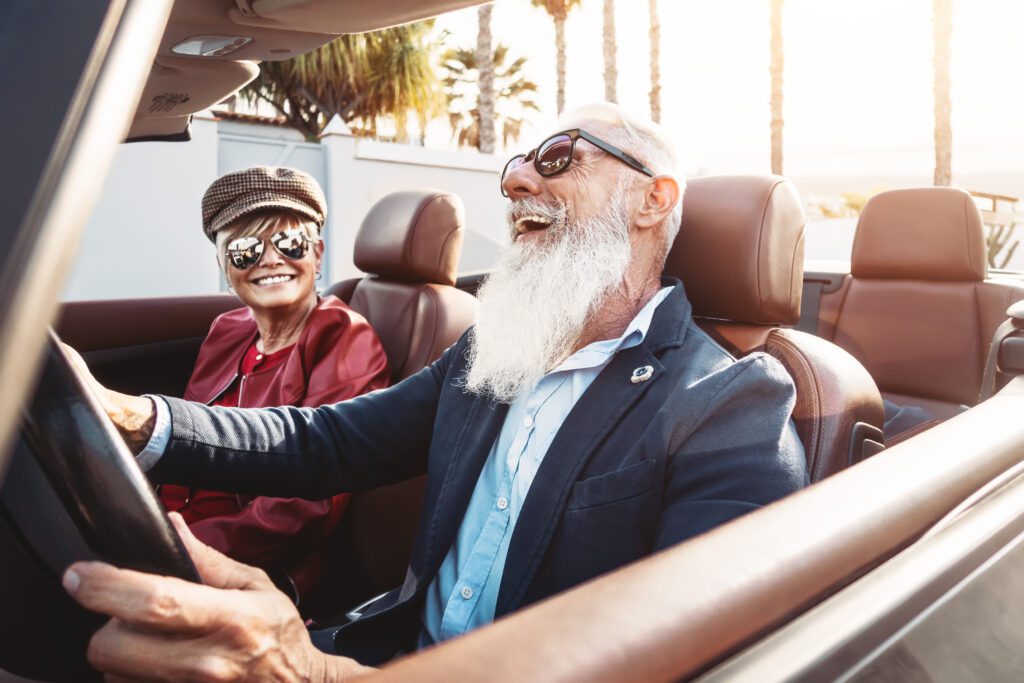 old man in convertible he bought after employing wealth protection strategies