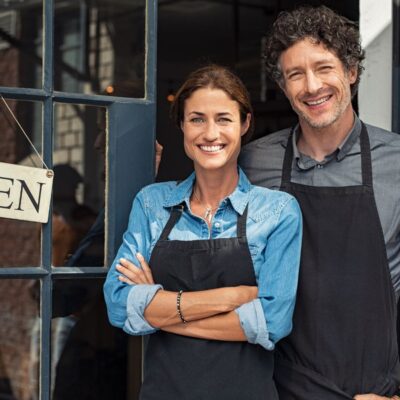 business owners in front of a shop for the article "what is the corporate transparency act"