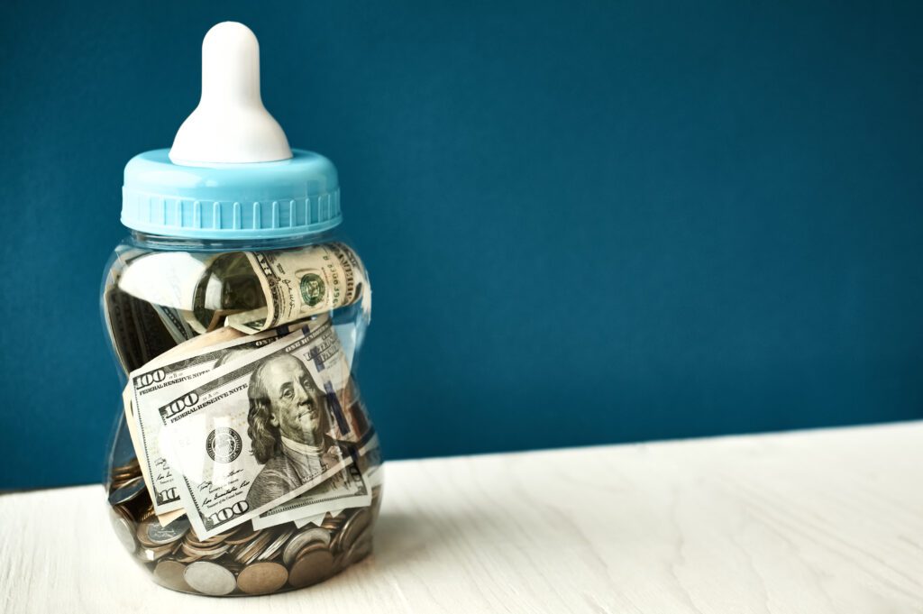 baby bottle with money in it for the blog "how to financially prepare for a baby"