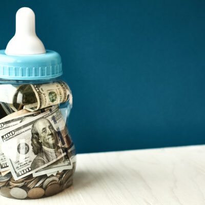 baby bottle with money in it for the blog "how to financially prepare for a baby"
